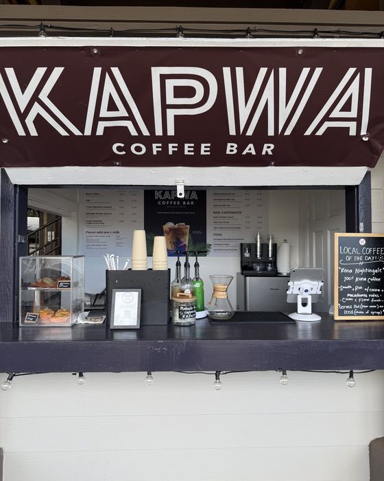 The Kapwa Coffee Bar kiosk counter under its maroon banner